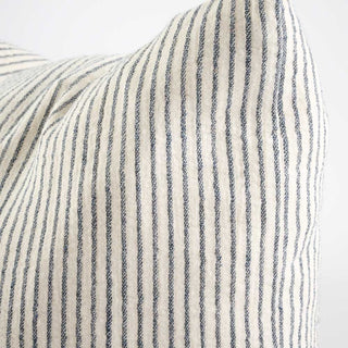 Close-up of a striped fabric with blue and white lines on a light gray background