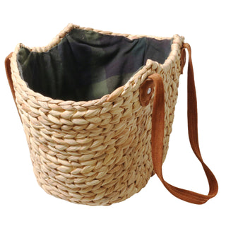 Woven handbag with a brown strap on a white background