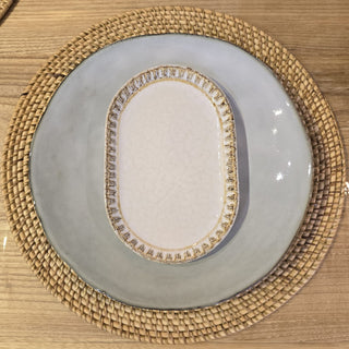 Decorative plate with gold rim on a woven placemat