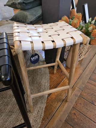 Wooden stool with woven seat in a casual indoor setting