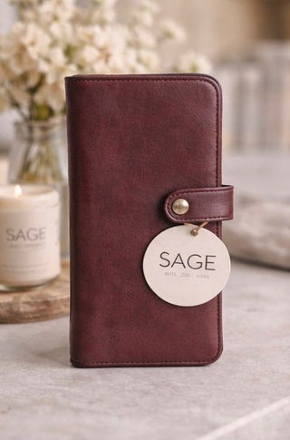 Brown leather wallet with 'SAGE' tag on a neutral background