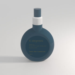 Blue perfume bottle with white cap on a light gray background