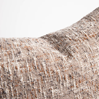 Close-up of a textured fabric with brown and beige colors on a white background