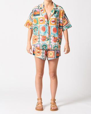 Person wearing a colorful patterned outfit on a white background