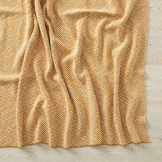 Textured gold fabric draped over a wooden surface