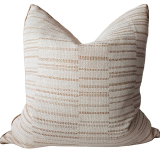 Textured pillow with beige and brown stripes on a white background