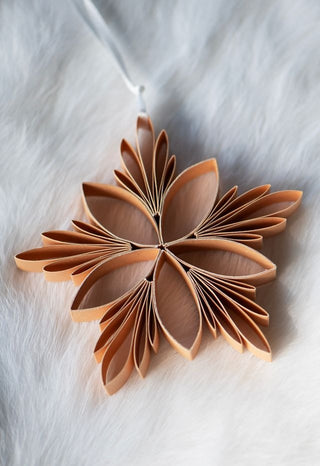 Decorative flower made of folded paper on a white background