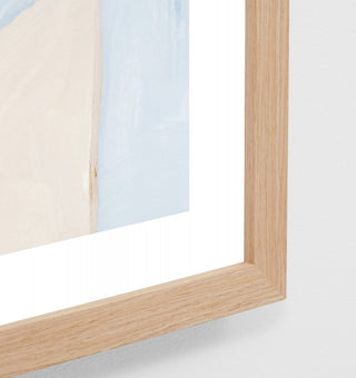 Close-up of a wooden picture frame with a glass front on a white background