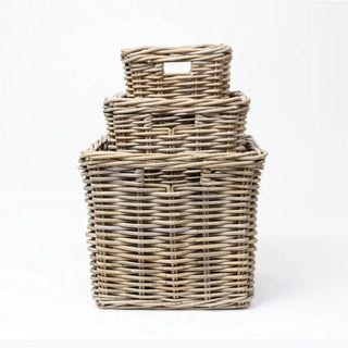 Set of three woven baskets on a white background