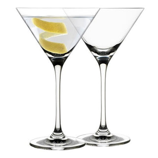 Two martini glasses with lemon wedges on a white background