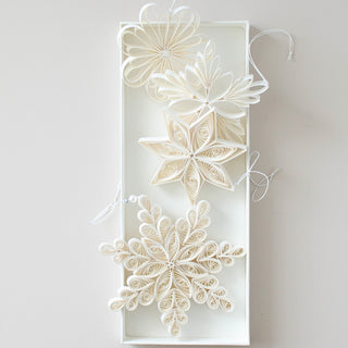 Decorative paper star in a white box on a light gray background