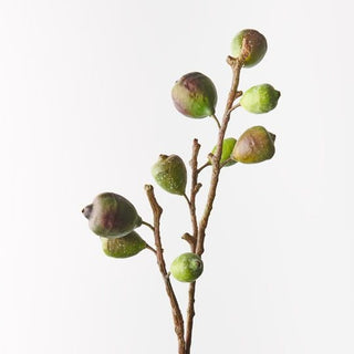 Artificial green berry branch on a white background