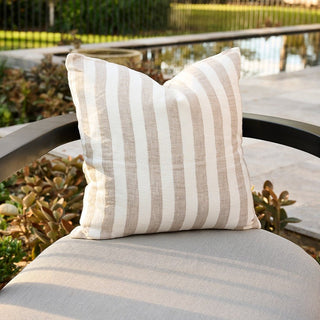 Striped pillow on a chair with a garden background