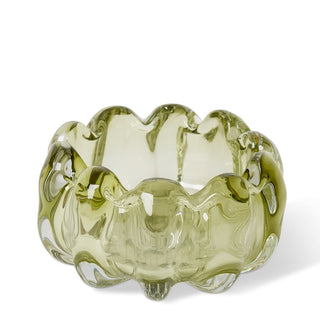 Green glass bowl with wavy design on a white background