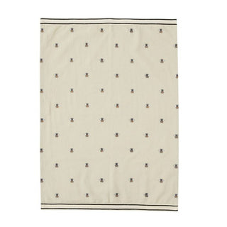 Beige blanket with small black pattern on a white background