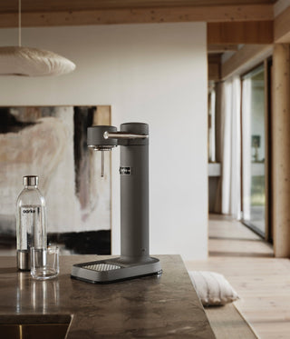 Modern kitchen with a sleek water dispenser on a countertop.