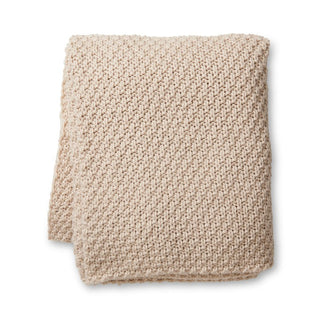 Beige knitted blanket on a white background