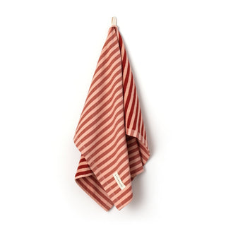Red and white striped towel hanging on a hook against a white background