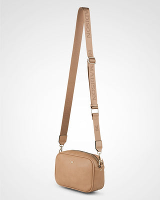 Beige crossbody bag with a strap on a light gray background