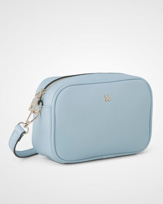 Light blue crossbody bag with a visible brand logo on a white background