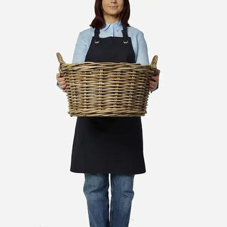 Person holding a large woven basket against a white background