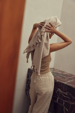 Person wrapped in a towel in a bathroom setting