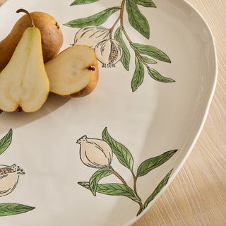 Decorative plate with pear illustrations on a wooden surface