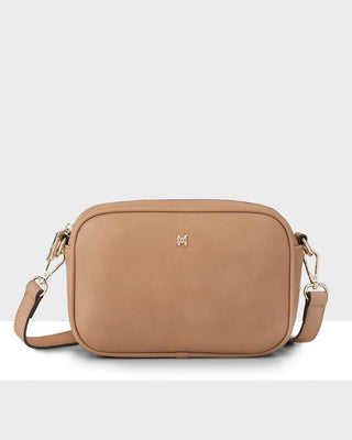 Tan crossbody bag with a visible brand logo on a white background