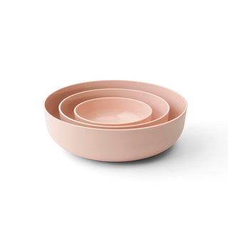 Set of three pink bowls of different sizes on a white background