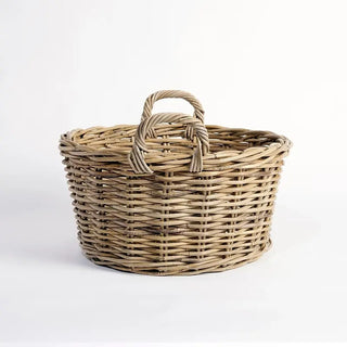 Wicker basket with handle on a white background