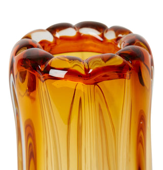 Amber glass vase with textured surface on a white background