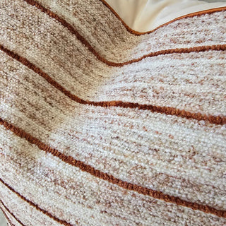 Close-up of a textured fabric with brown and beige stripes