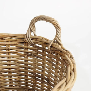 Close-up of a wicker basket with a handle on a white background