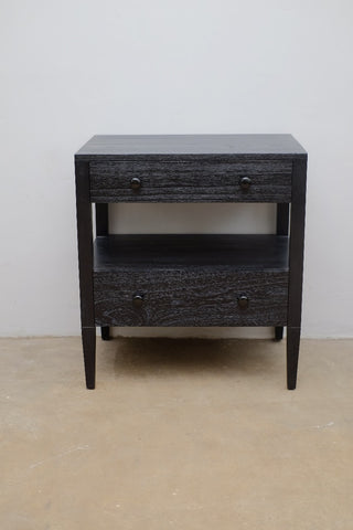 Dark wooden nightstand with a single drawer on a plain background