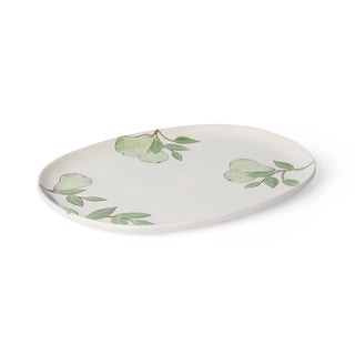 Ceramic plate with green leaf design on a white background