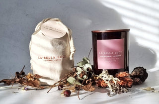 La Bella Luce candle and packaging with dried flowers on a light background