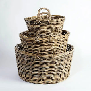Set of three woven baskets of different sizes on a white background