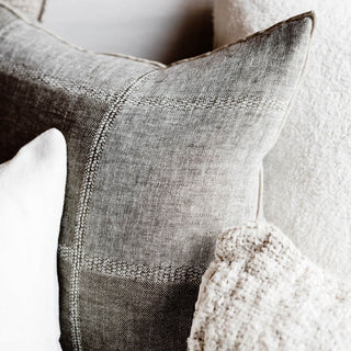 Close-up of a textured gray pillow with a white background