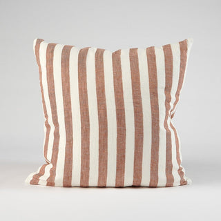 Striped pillow with brown and white vertical stripes on a gray background