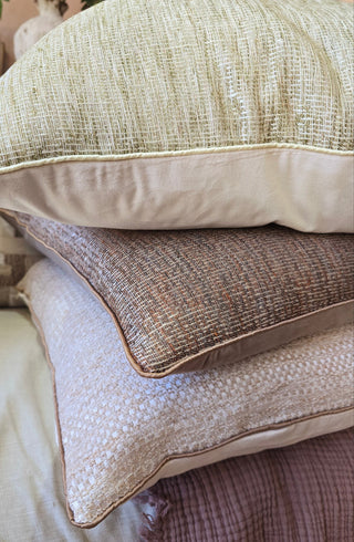 Stack of textured pillows on a sofa