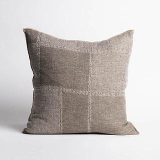 Gray pillow with decorative stitching on a white background