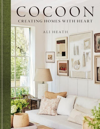 Book cover of 'Cocoon: Creating Homes with Heart' by Ali Heath, featuring a living room interior.