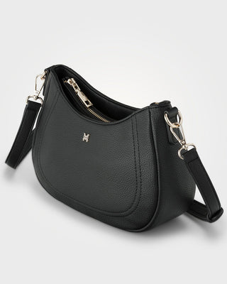 Black leather handbag with a visible brand logo on a light gray background