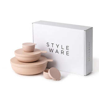 Set of pink ceramic bowls with lids in front of a 'STYLE WARE' box on a white background