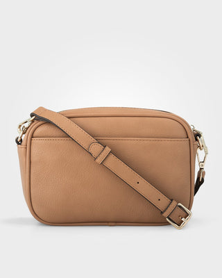 Tan crossbody bag on a light gray background