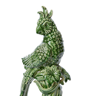 Green ceramic parrot sculpture on a white background