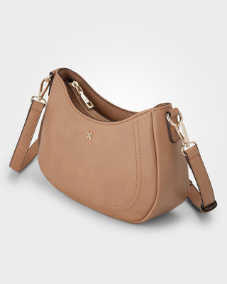 Brown handbag with a gold zipper and matching strap on a light gray background