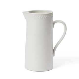 White ceramic pitcher on a white background