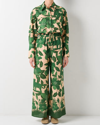 Green and beige floral patterned jumpsuit on a white background