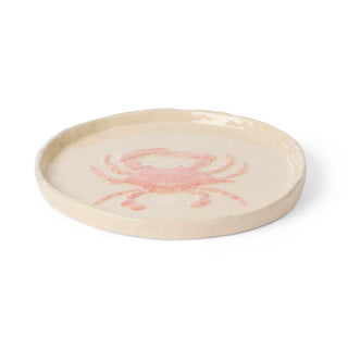 Round ceramic dish with a pink crab design on a white background